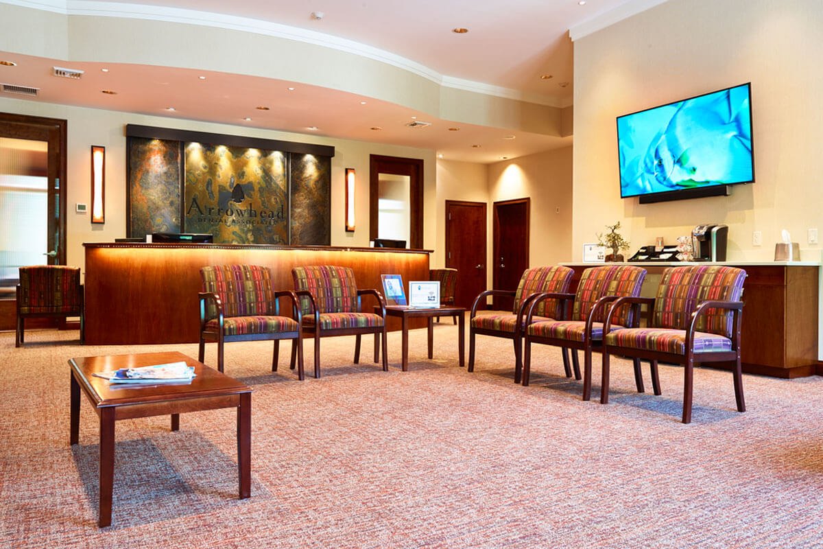 Arrowhead dental associates waiting area with colored chairs and coffee area