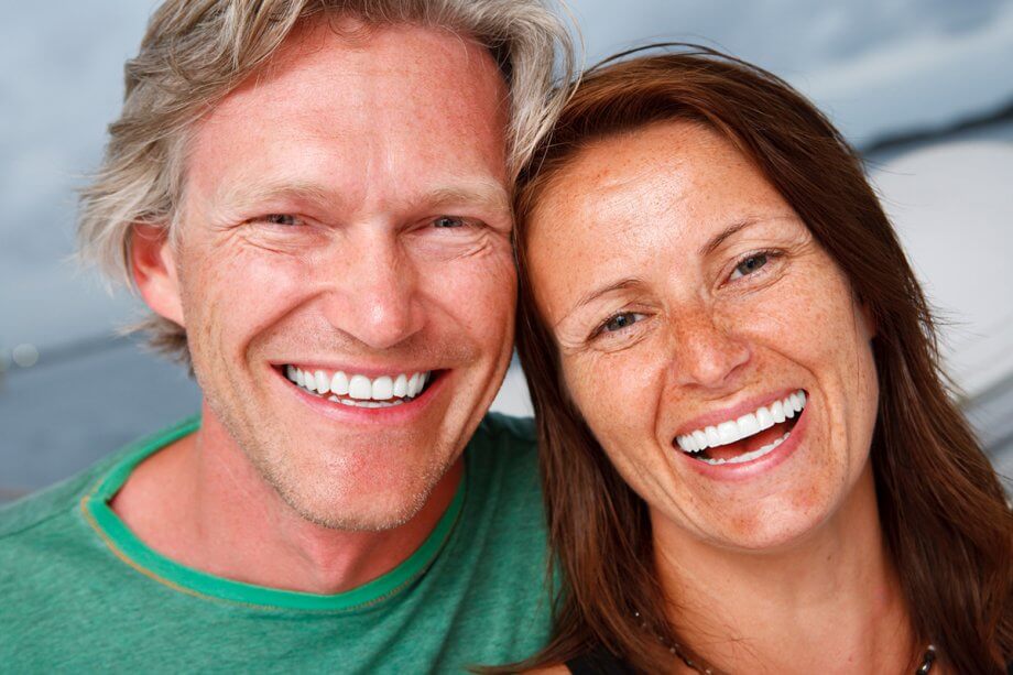 smiling man and woman facing camera